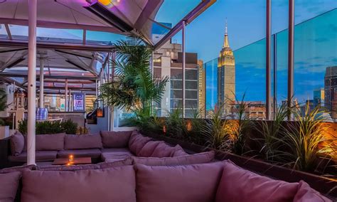 What rooftop bar looks at the Empire State Building?