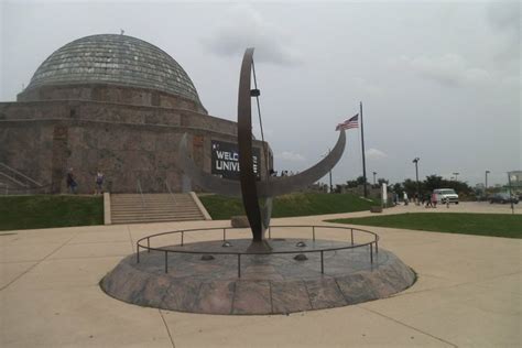 What statue is in front of the Adler Planetarium?