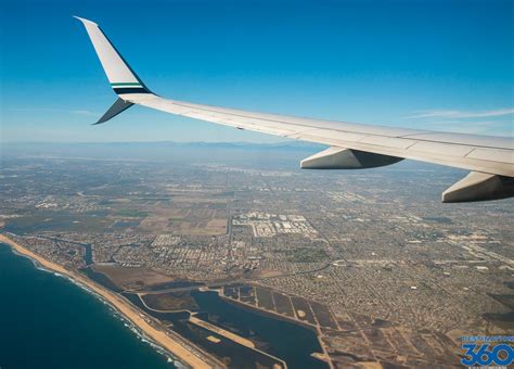 Where is it cheaper to fly into in California?