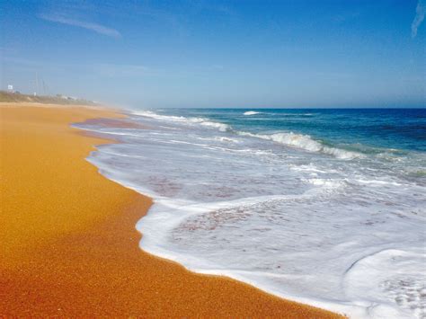 What beach has orange sand in Florida?